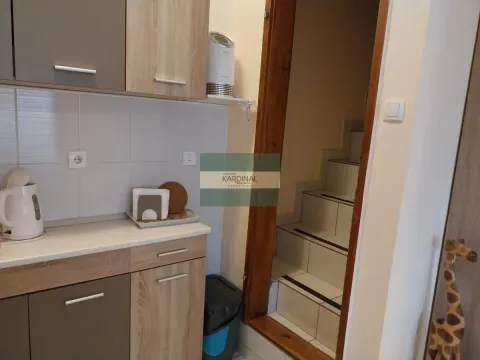 Pogled na deo kuhinje sa elementima i prolazom prema stepenicama. - image 9
