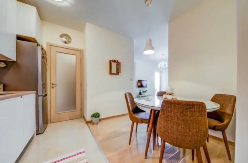 Dining area with a table and chairs connected to the kitchen.