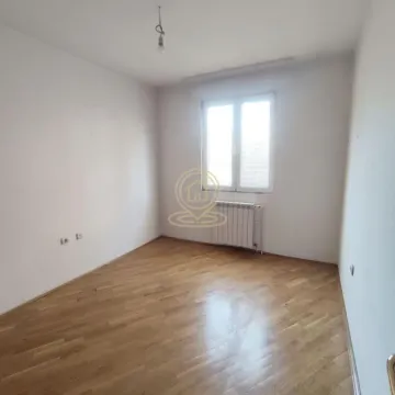Empty room with hardwood floors and a window. - image 5