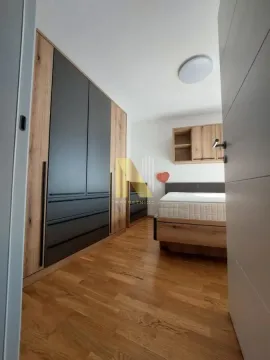 Nameštena spavaća soba sa velikim ugradnim plakarom i krevetom. - image 10