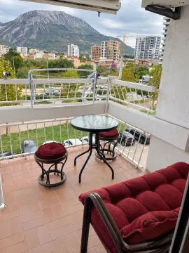Furnished balcony with seating set and city and mountain views. - image 5