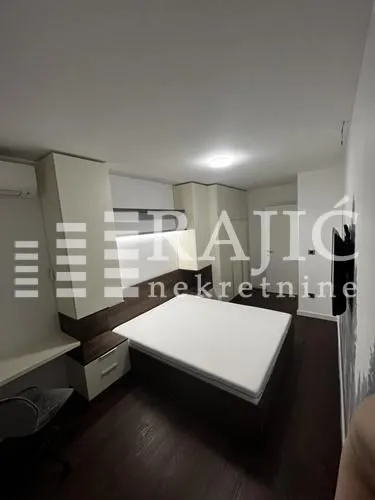 Modern bedroom with a double bed and fitted closets.