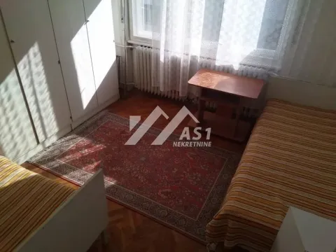 Furnished bedroom with two beds, wardrobe and a window. - image 5