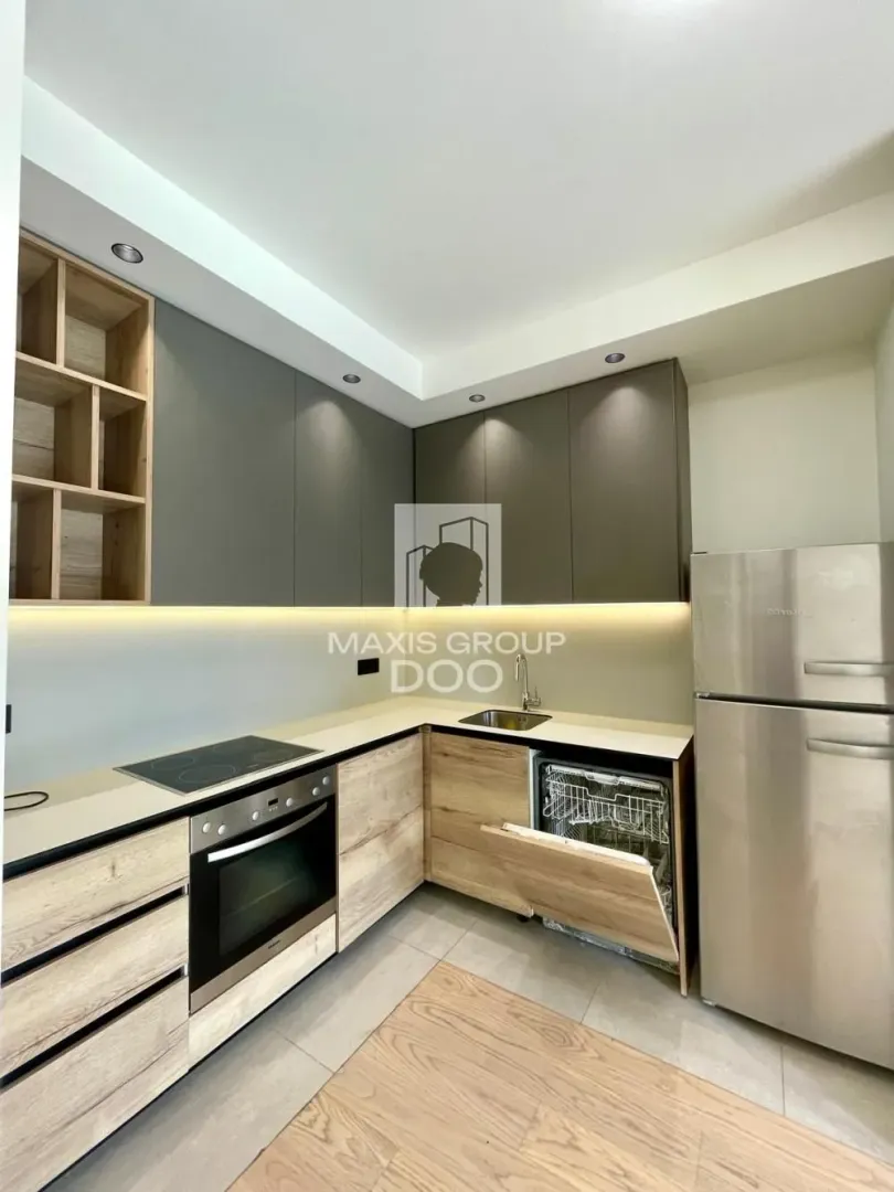 Modern kitchen with built-in units and refrigerator.