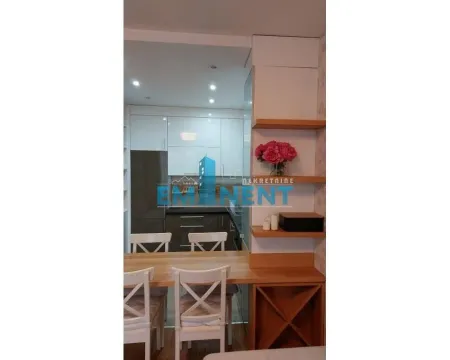 Modern kitchen with a bar counter and dining table. - image 4
