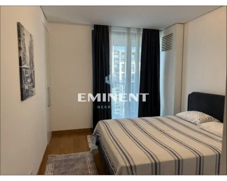 Furnished bedroom with a double bed, wardrobe, and a window with dark curtains. - image 10