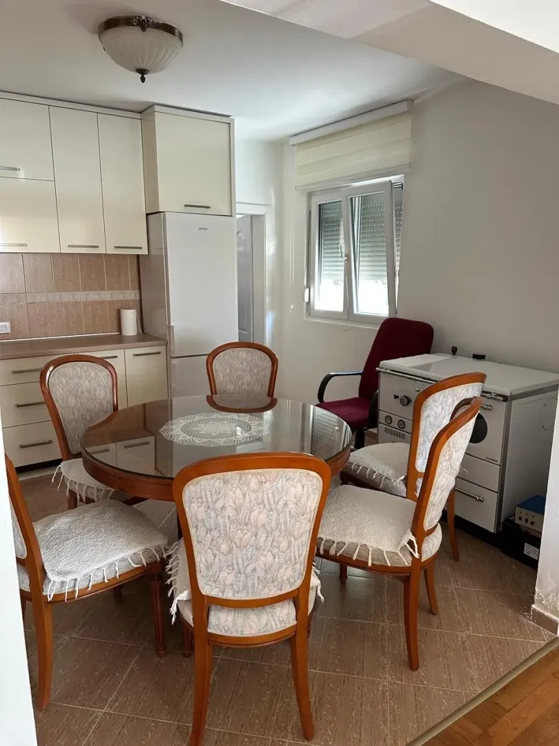Dining area with a table and chairs connected to the kitchen.