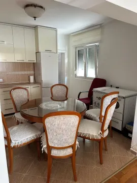 Dining area with a table and chairs connected to the kitchen. - image 12
