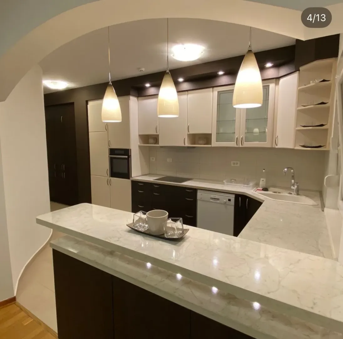 Modern kitchen with a breakfast bar and upper cabinets.