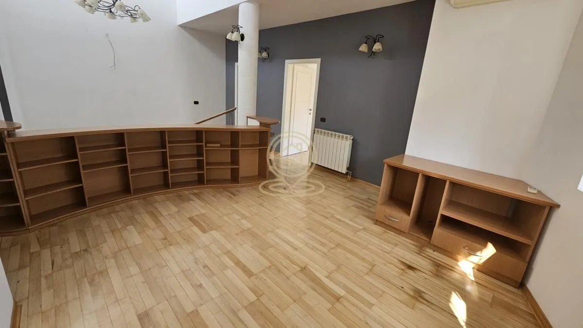 Spacious living room with wooden elements and laminate flooring.