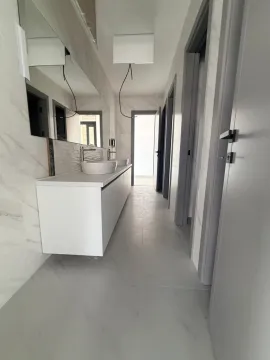 Modern bathroom with two washbasins and a large mirror. - image 7