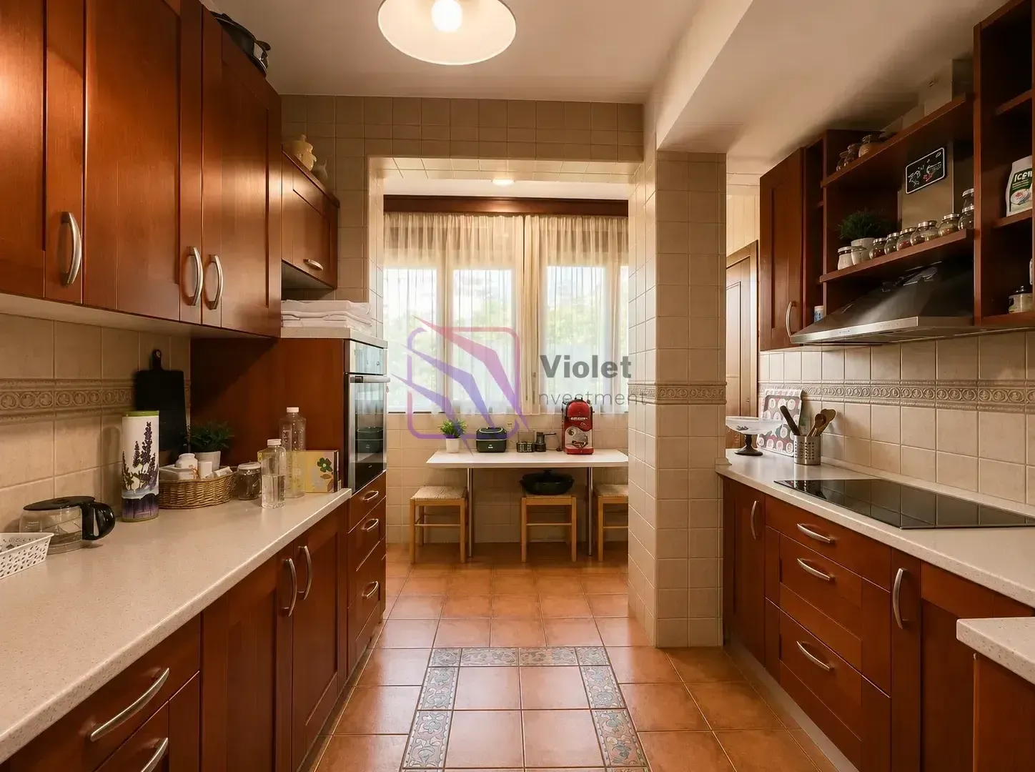 Traditional kitchen with wooden cabinetry and a dining area by the window.