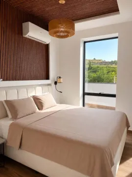 Modern bedroom with a double bed, wooden wall panels, and a view of nature. - image 5
