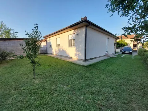 Exterior of a single-story house with a neat green lawn. - image 13