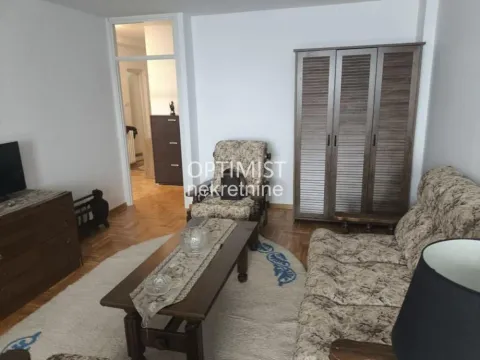 Living room with a sofa set, wooden wardrobe, and table. - image 2