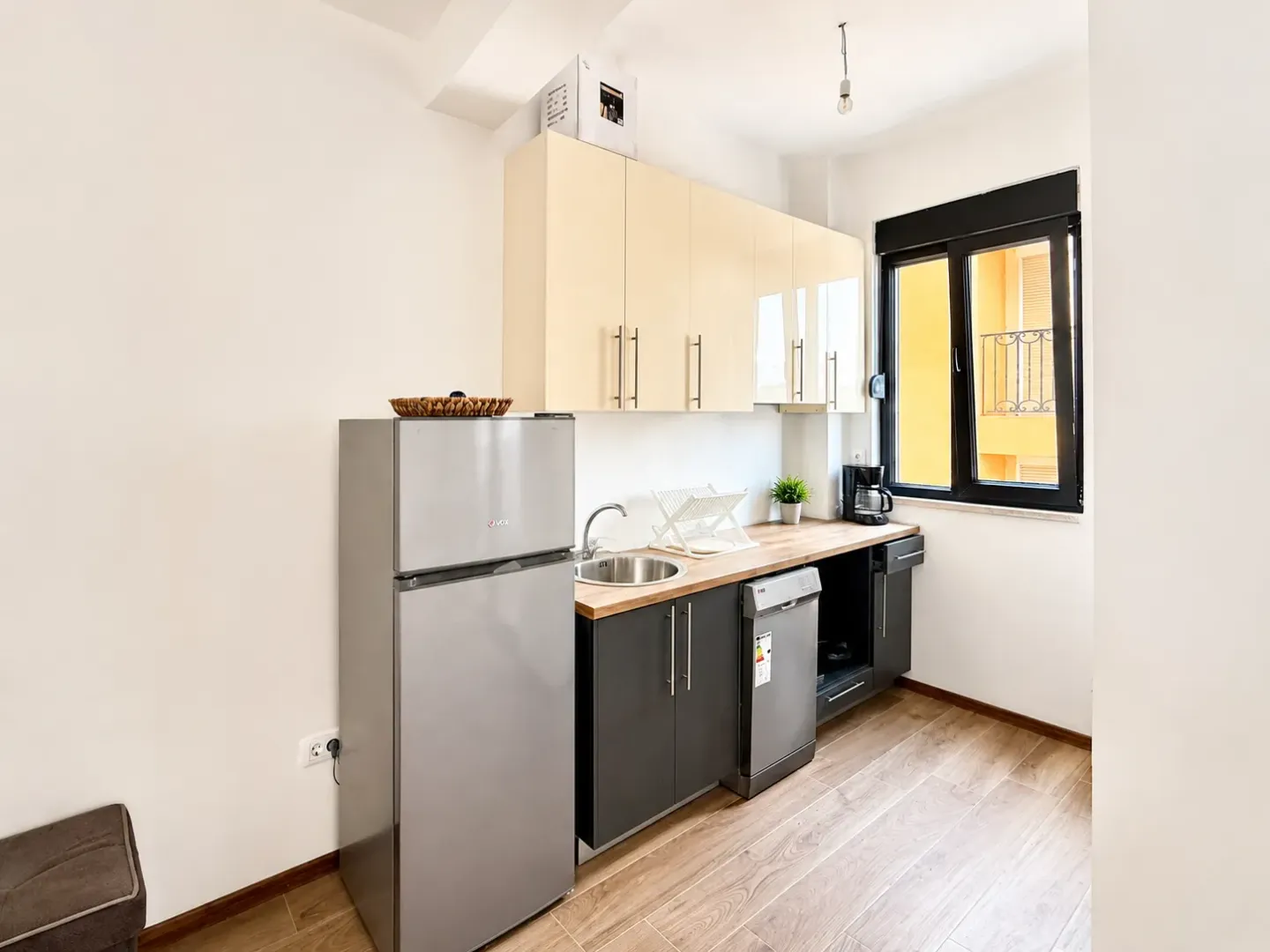 Smaller kitchen with light cabinets and built-in appliances.