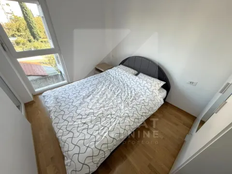 Small bedroom with a double bed, nightstand, and a window. - image 5