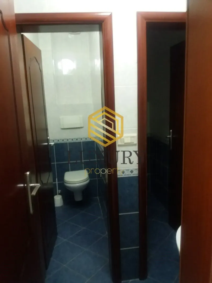 View of the bathroom through an open door.