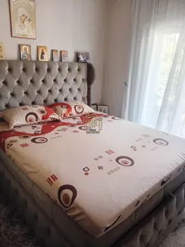Furnished bedroom with a large double bed and decorative elements on the wall. - image 3