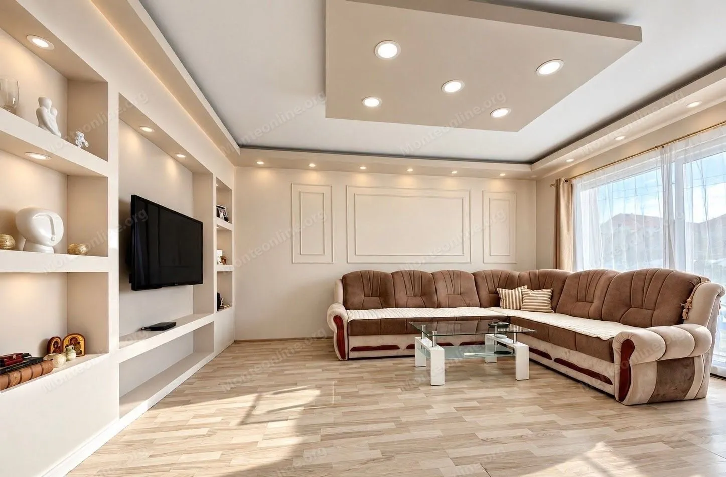 Living room with a sectional sofa, built-in shelving, and a TV.