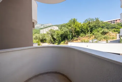 View from the semicircular balcony towards the surrounding greenery and buildings. - image 9