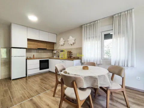 Kitchen with dining area and white cabinetry. - image 12