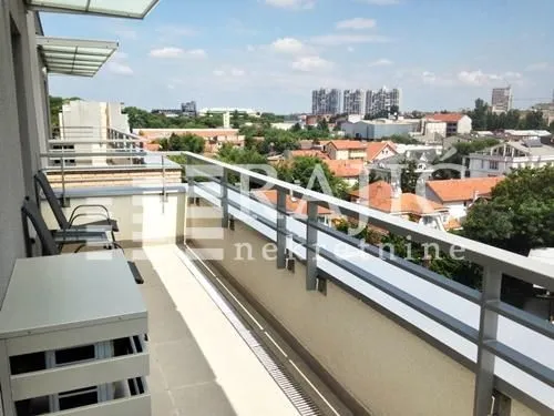 Spacious balcony with outdoor seating and a city view.