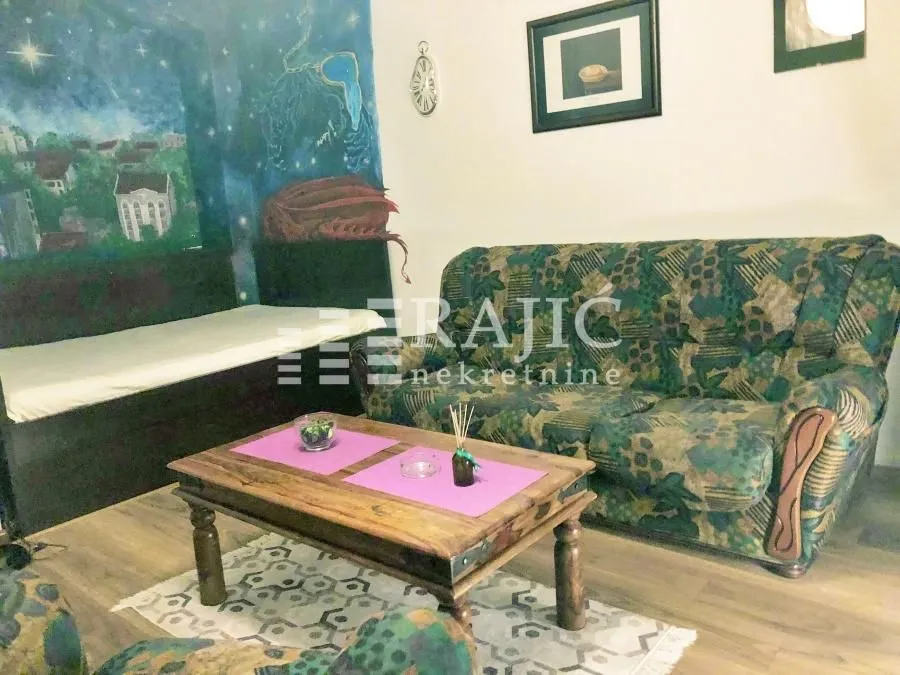 Living room with a sofa set and a wooden coffee table.