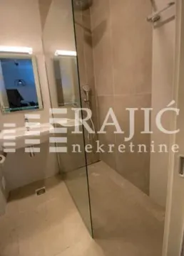 Modern equipped bathroom with a walk-in shower. - image 10
