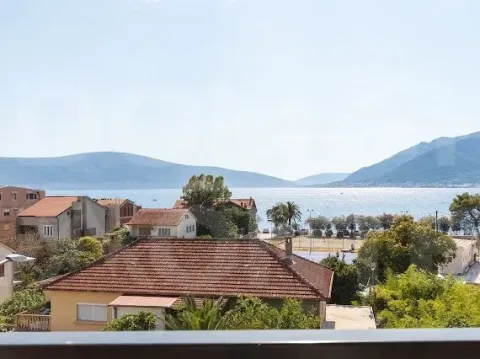 View from the terrace overlooking the sea and surrounding buildings. - image 5