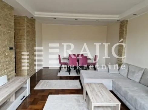 Spacious living room with a sofa and dining area.