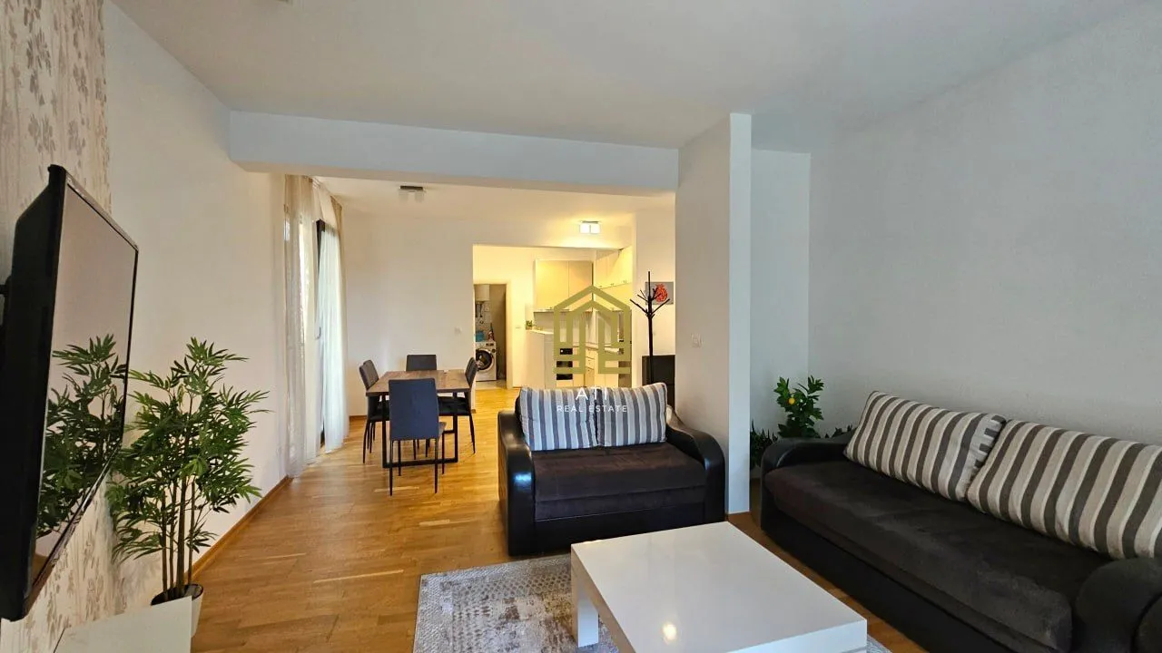 Spacious living room with seating area, dining space, and a view of the kitchen.