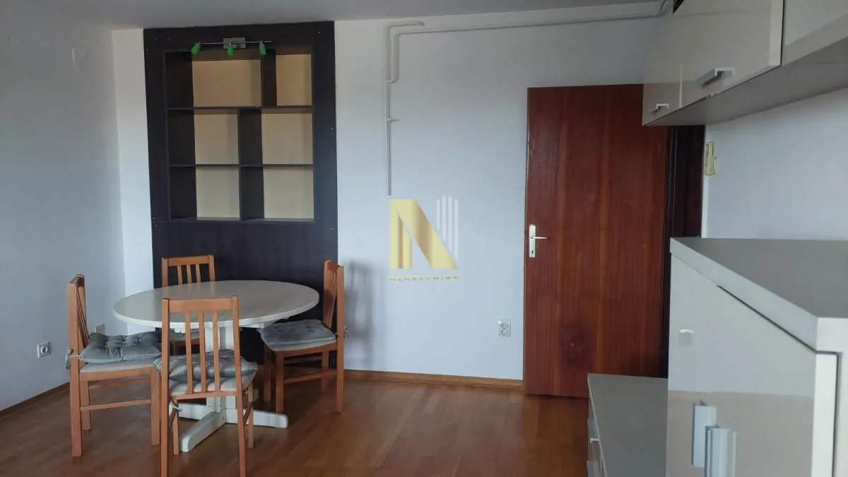 Dining area with a table, chairs, and built-in units.