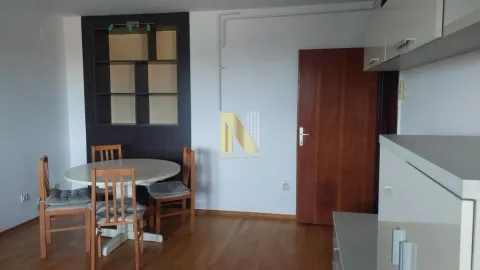 Dining area with a table, chairs, and built-in units. - image 4