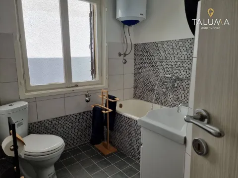 Smaller bathroom with a bathtub, washbasin, and a window. - image 3
