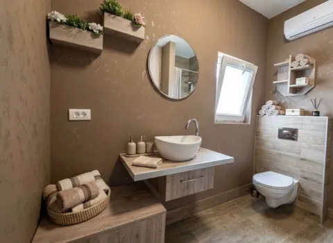 Modern bathroom with a sink, mirror, and toilet in brown tones. - image 7