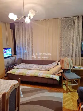 Living room with a sofa bed and a curtained window. - image 5