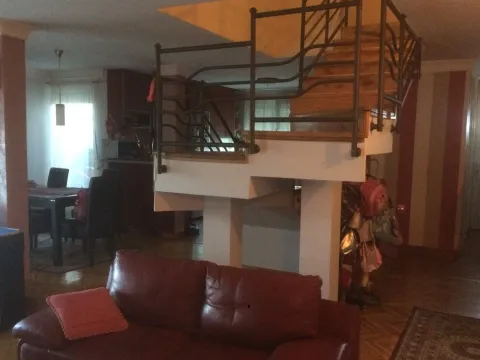 Living room with a leather sofa and an internal staircase. - image 10