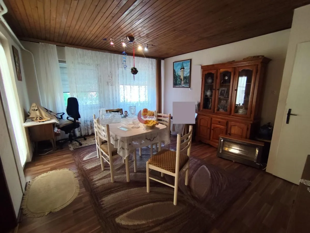 Living room with a dining table and wooden furniture.