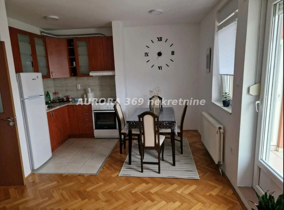 Kitchen with dining area and wooden furniture.