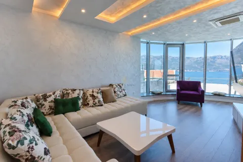 Living room with sectional sofa, modern ceiling design, and sea view. - image 2