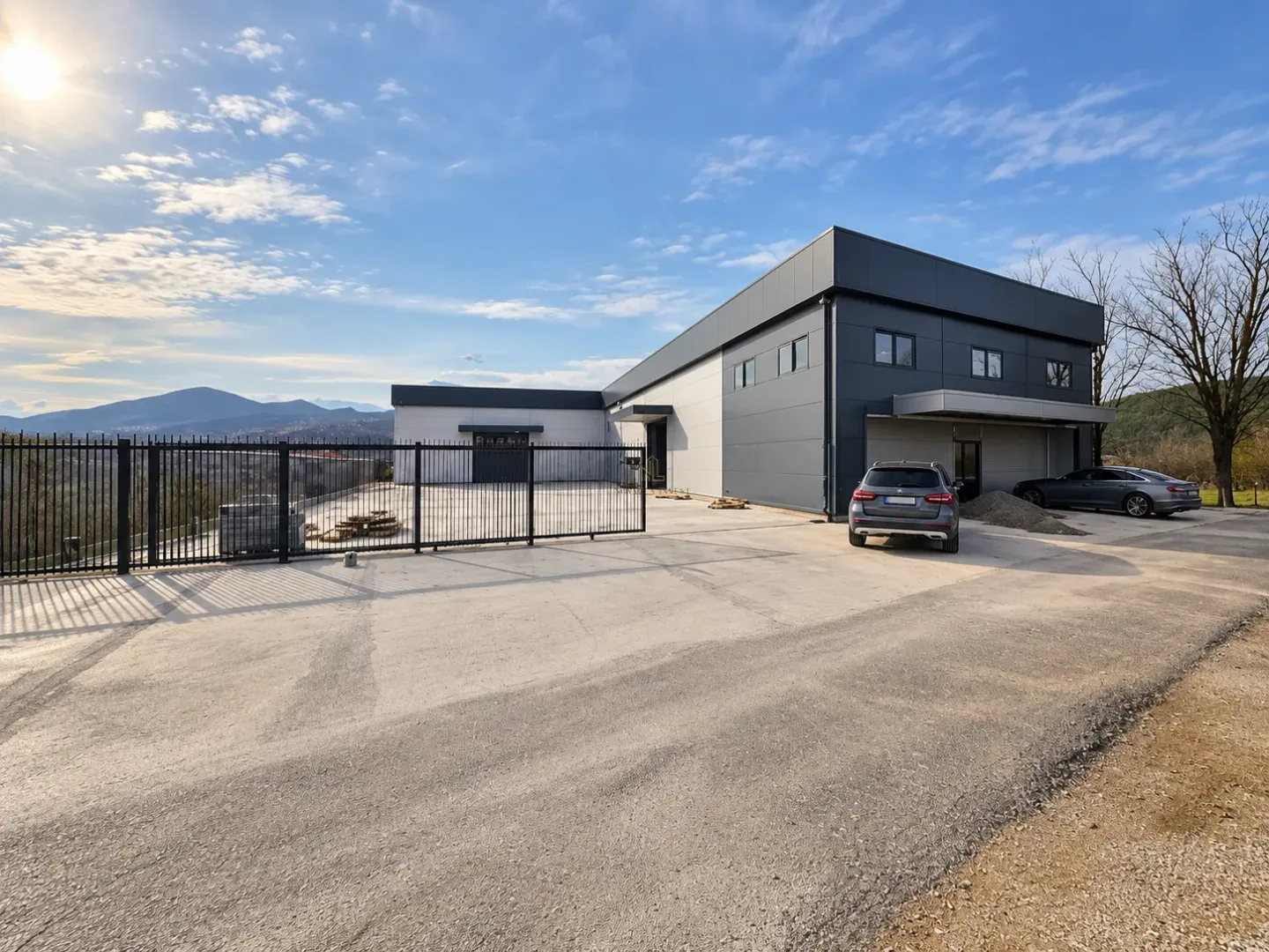 View of the exterior of the commercial building with a yard and parking area.