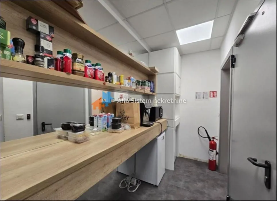 Auxiliary kitchen with wooden shelves and a countertop.