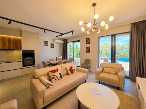 Living room with sofa set, dining area, and open-plan kitchen with access to the terrace. - image 13