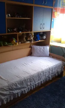Children's bedroom with a bed and blue wardrobes. - image 8