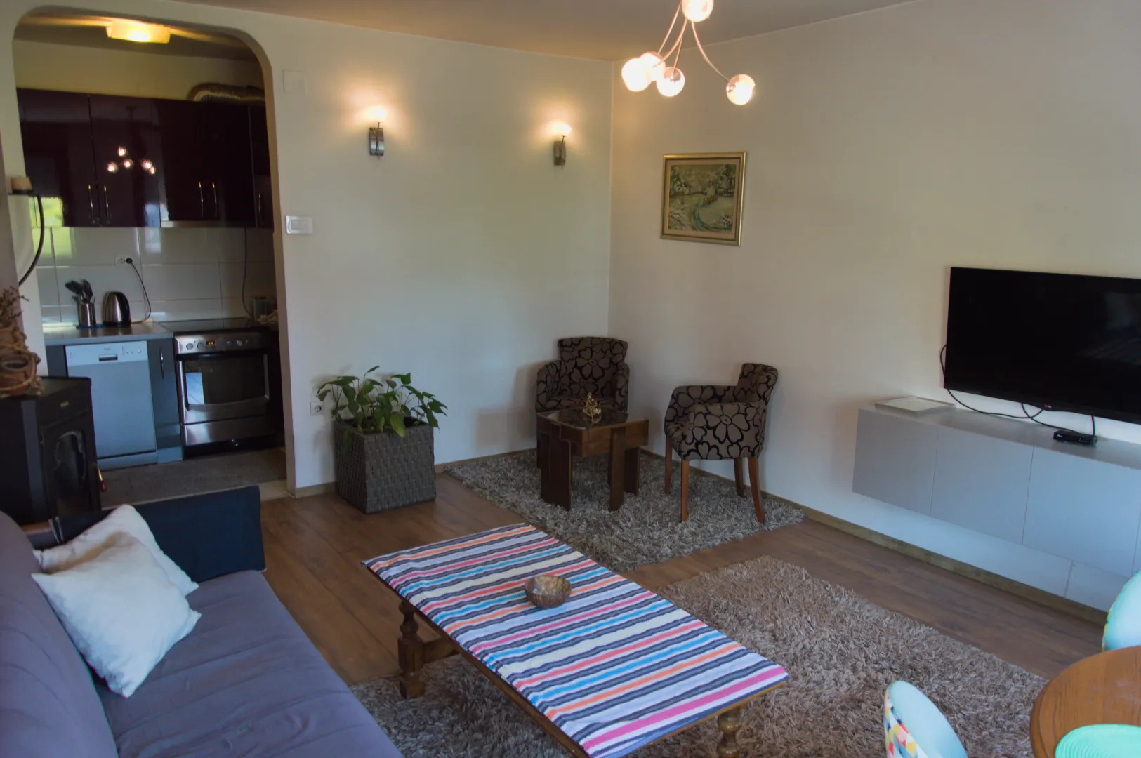 Living room connected to the dining area with a view of the kitchen.