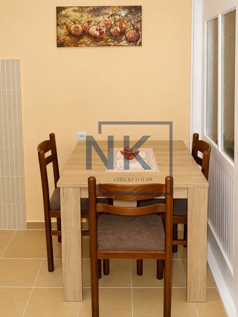 Dining table with chairs in a bright room.
