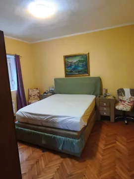 Furnished bedroom with a double bed, nightstands, and wooden flooring. - image 9