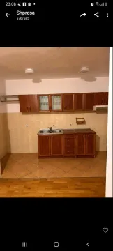 Kitchen with wooden cabinets and ceramic tiles. - image 3