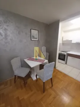 Trpezarija sa stolom i stolicama i pogledom na kuhinju. - image 4